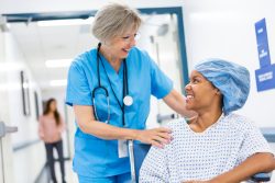 Nurse caring for female patient in wheelchair