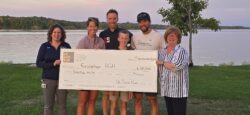 Bay run team holding the check