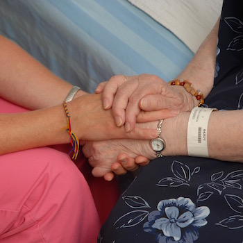 Staff and patient holding hands