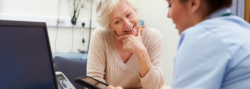 Patient and nurse looking at medical device